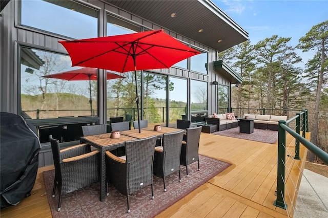 wooden terrace with grilling area and an outdoor hangout area