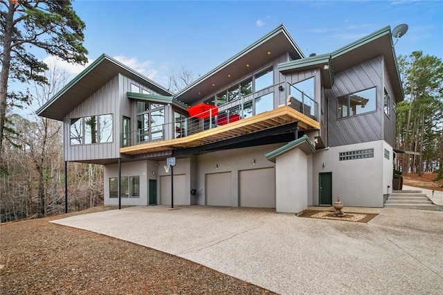 back of property featuring a garage and a balcony