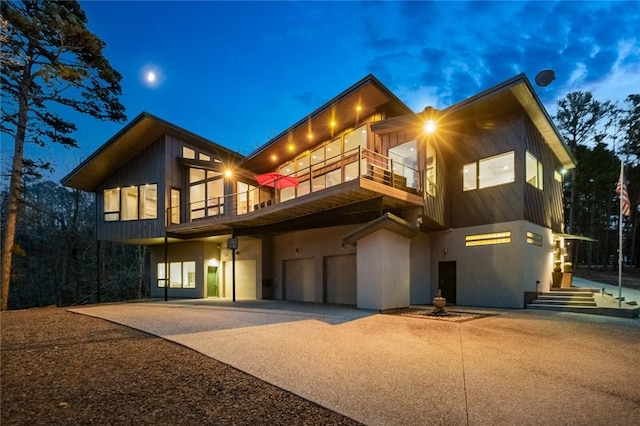 view of front of home featuring a balcony and a garage