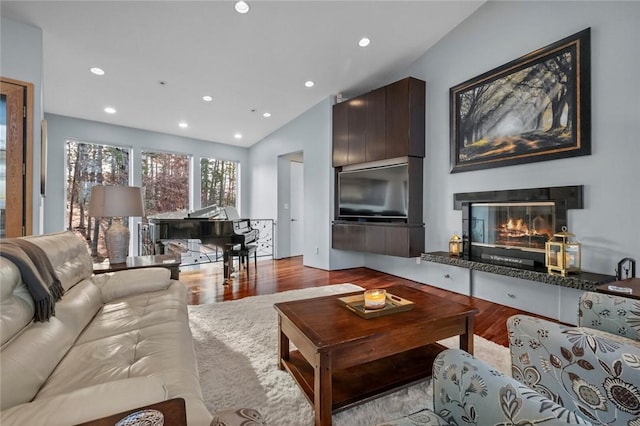 living room with light hardwood / wood-style floors and lofted ceiling