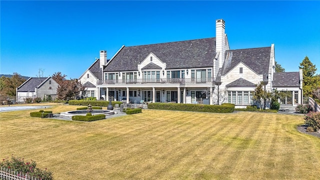 exterior space featuring a balcony and a front lawn