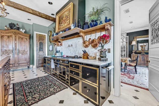 kitchen featuring light tile patterned floors, stainless steel gas cooktop, and ornamental molding