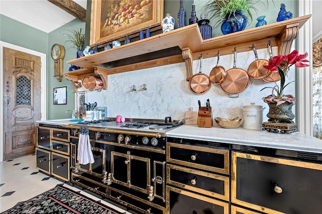 kitchen featuring gas cooktop, lofted ceiling, and sink