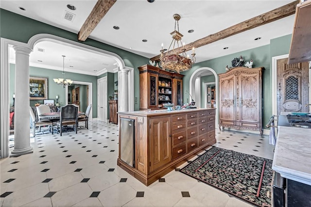 kitchen featuring an inviting chandelier, beamed ceiling, a kitchen island, hanging light fixtures, and light tile patterned flooring