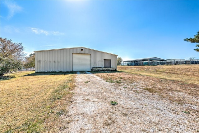 view of outbuilding with a lawn and a garage