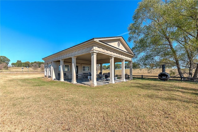 exterior space with a patio area and a lawn