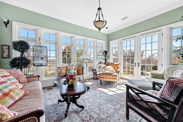 sunroom / solarium featuring french doors