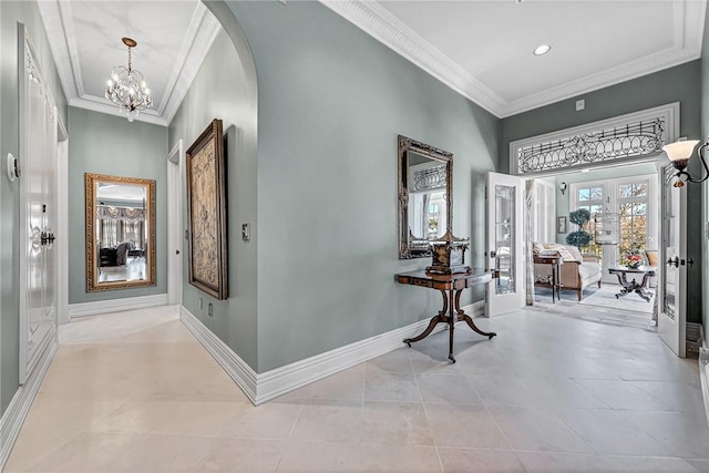 hall with crown molding, french doors, light tile patterned floors, and a notable chandelier