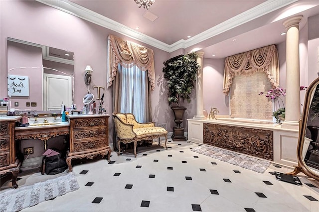 bathroom with vanity, crown molding, ornate columns, and a tub to relax in