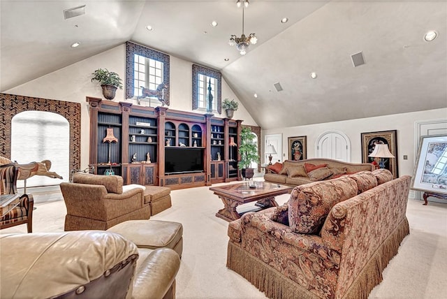 carpeted living room with high vaulted ceiling and an inviting chandelier