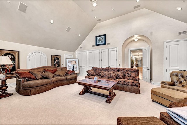 living room featuring light colored carpet and high vaulted ceiling