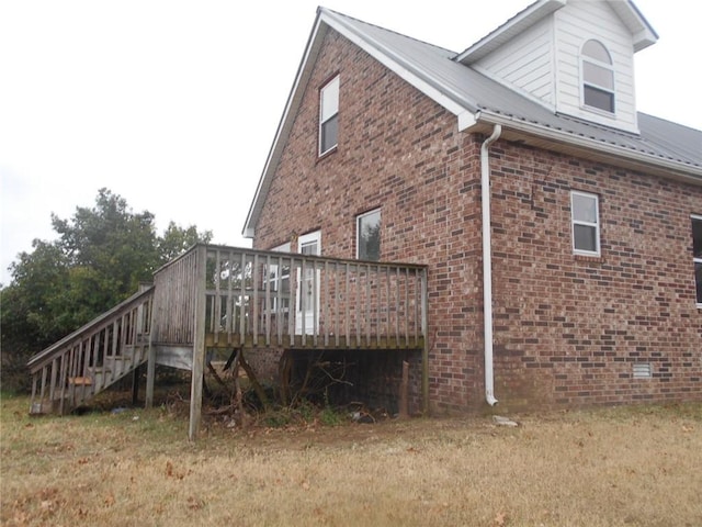 view of side of property featuring a wooden deck