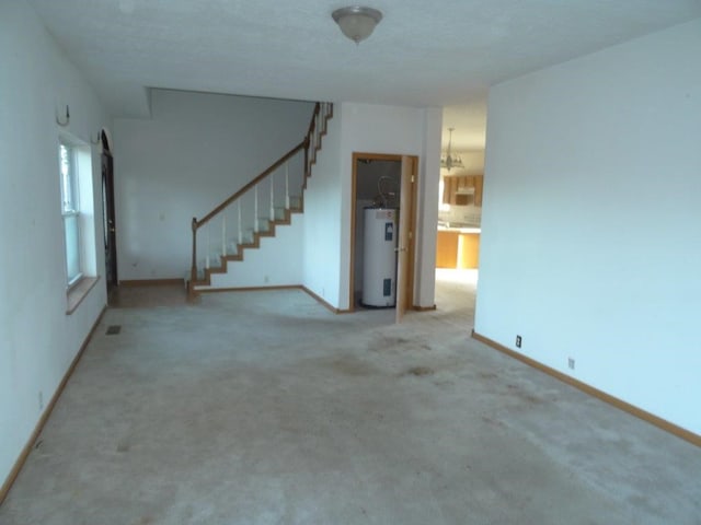 unfurnished living room featuring electric water heater and light carpet