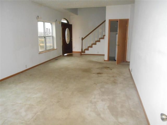 foyer featuring carpet flooring