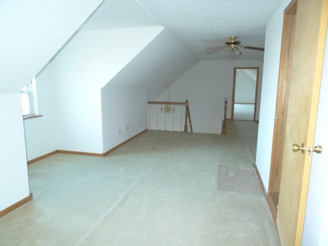 bonus room with ceiling fan, light carpet, and lofted ceiling