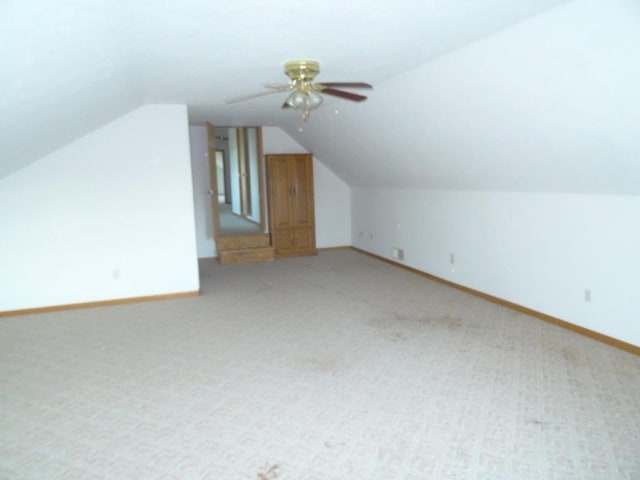 bonus room featuring light colored carpet, vaulted ceiling, and ceiling fan