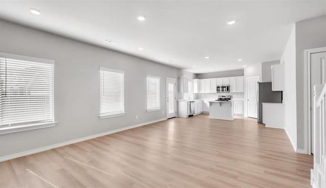 unfurnished living room featuring light hardwood / wood-style floors