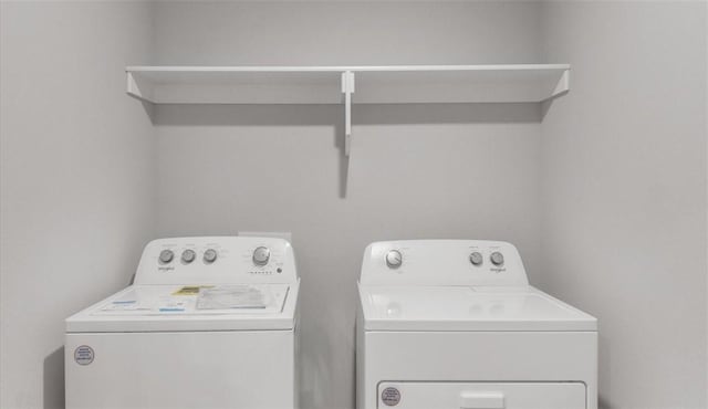 laundry room with washing machine and clothes dryer