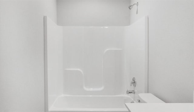 bathroom with shower / bath combination and toilet