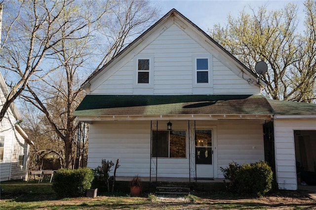 back of house featuring a porch