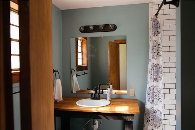 bathroom with curtained shower and sink