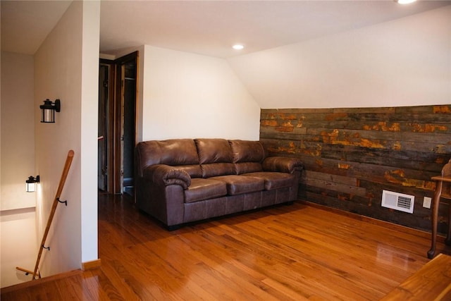 living room featuring hardwood / wood-style flooring and lofted ceiling