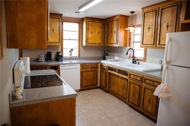 kitchen featuring pendant lighting, white appliances, sink, and light tile patterned floors