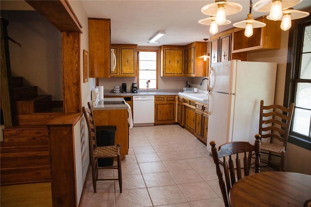 kitchen featuring ceiling fan, sink, hanging light fixtures, white appliances, and light tile patterned floors