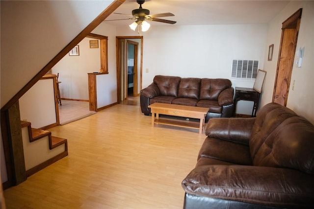 living room featuring light hardwood / wood-style flooring and ceiling fan