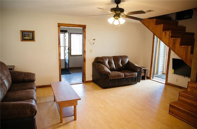 living room featuring light hardwood / wood-style floors and ceiling fan