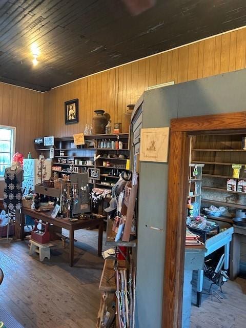 office space featuring a workshop area, hardwood / wood-style floors, and wooden walls