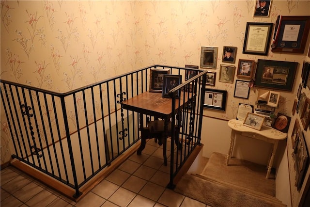 staircase featuring tile patterned flooring