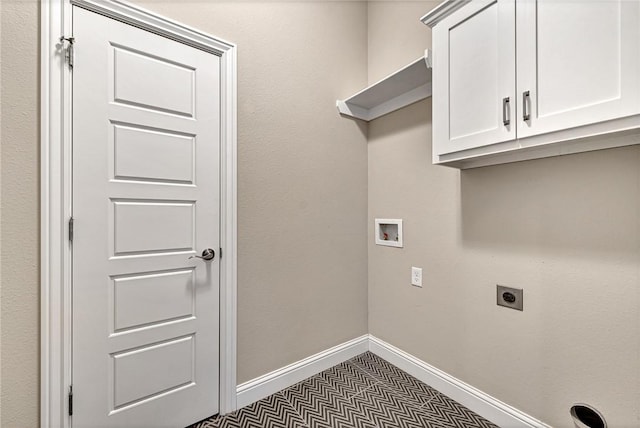 clothes washing area with hookup for a washing machine, cabinets, and hookup for an electric dryer