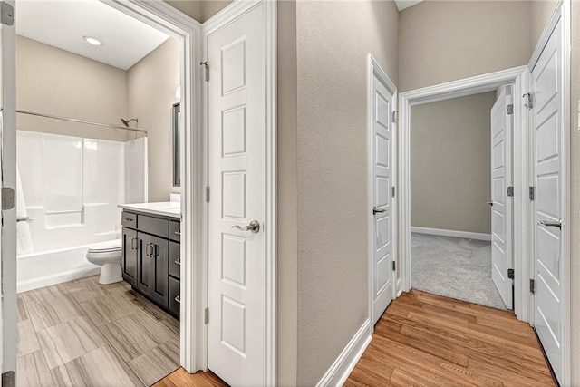 full bathroom featuring vanity,  shower combination, toilet, and wood-type flooring