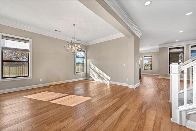 unfurnished room with light hardwood / wood-style flooring, plenty of natural light, and crown molding