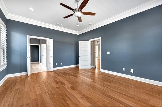 unfurnished bedroom featuring light hardwood / wood-style floors, ceiling fan, and crown molding