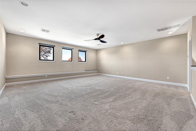 empty room with ceiling fan and light colored carpet