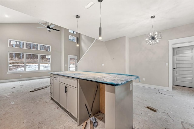 kitchen with ceiling fan with notable chandelier, a kitchen island, pendant lighting, and high vaulted ceiling