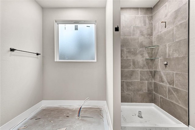 bathroom with a tile shower