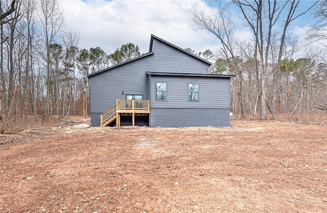 rear view of property with a wooden deck