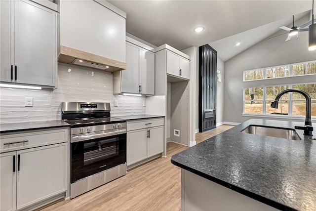 117 Kinross Dr, Bella Vista, AR 72715 - kitchen with stainless steel range with electric stovetop, dark countertops, tasteful backsplash, light wood-style flooring, and lofted ceiling