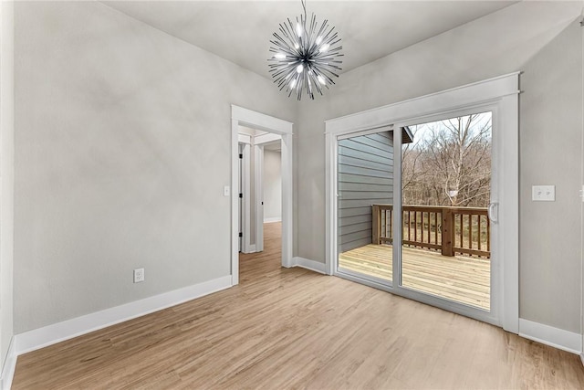 117 Kinross Dr, Bella Vista, AR 72715 - spare room with a chandelier and wood finished floors