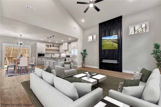 117 Kinross Dr, Bella Vista, AR 72715 - living room with light wood-type flooring, a ceiling fan, recessed lighting, and high vaulted ceiling