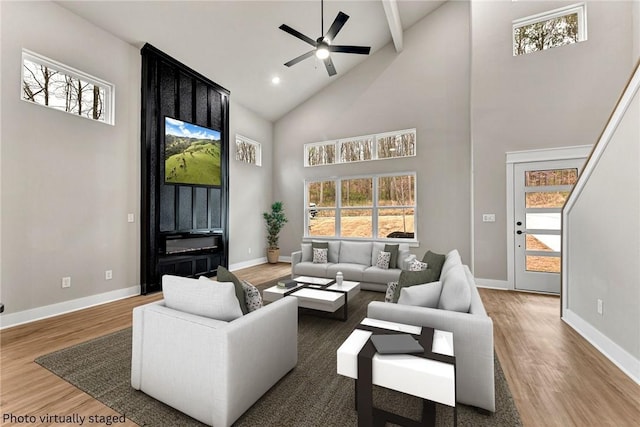 117 Kinross Dr, Bella Vista, AR 72715 - living area featuring high vaulted ceiling, wood finished floors, healthy amount of natural light, ceiling fan, and beam ceiling