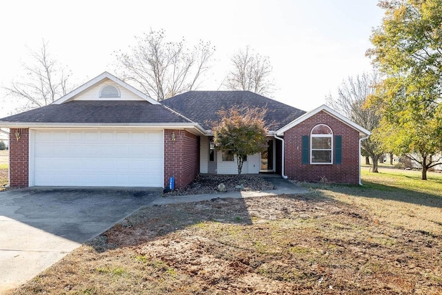 single story home with a front yard and a garage