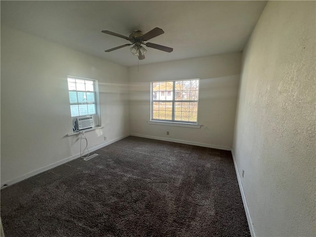 carpeted spare room featuring ceiling fan and cooling unit