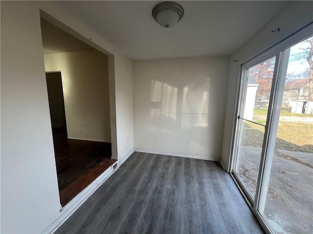 unfurnished room featuring dark hardwood / wood-style flooring