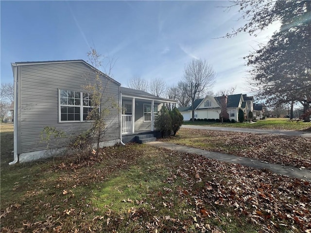 view of side of property with a porch