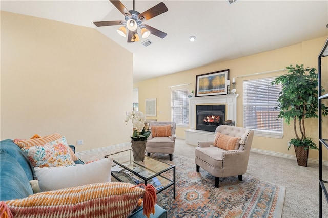 living room featuring light colored carpet, vaulted ceiling, and ceiling fan