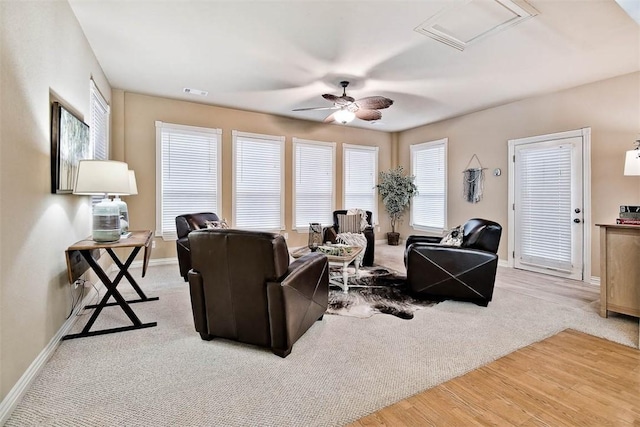 living area with a ceiling fan, carpet, visible vents, and baseboards